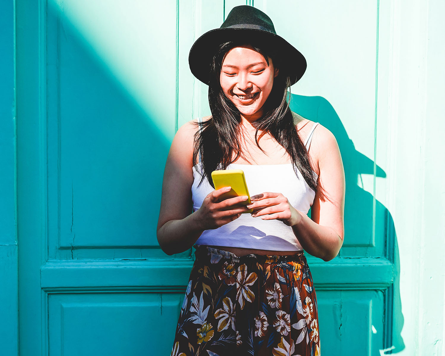 women wearing a hat on mobile device