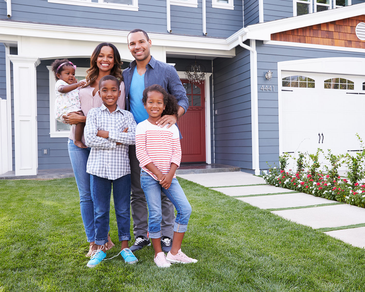 family in front of new house