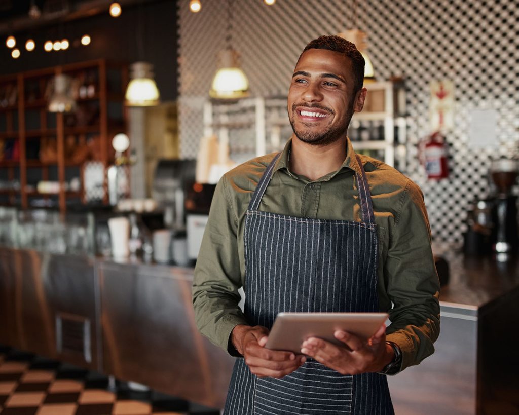 businessman smiling near restaurant equipment