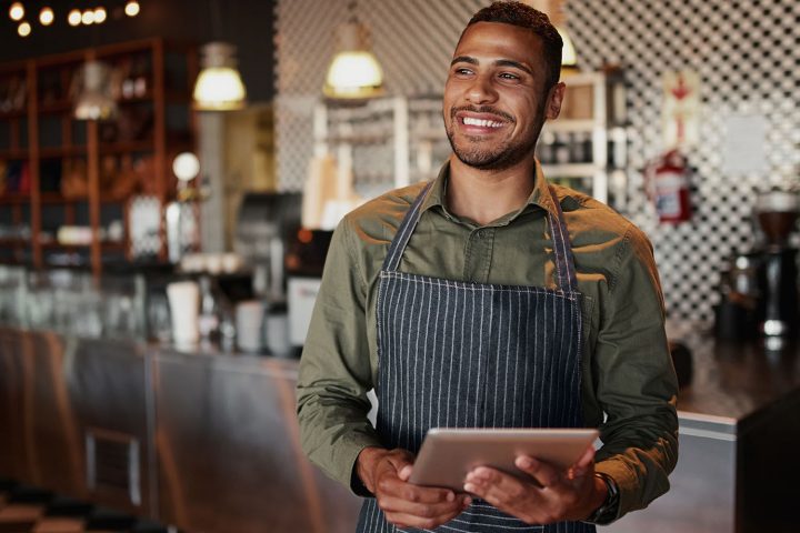 businessman smiling near restaurant equipment